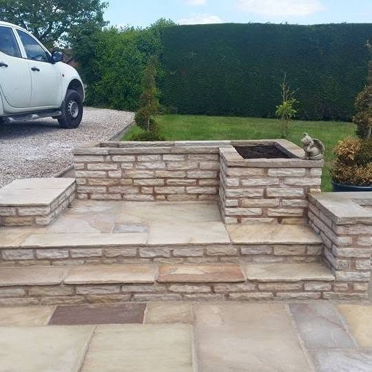 Indian stone patio steps with a raised bed