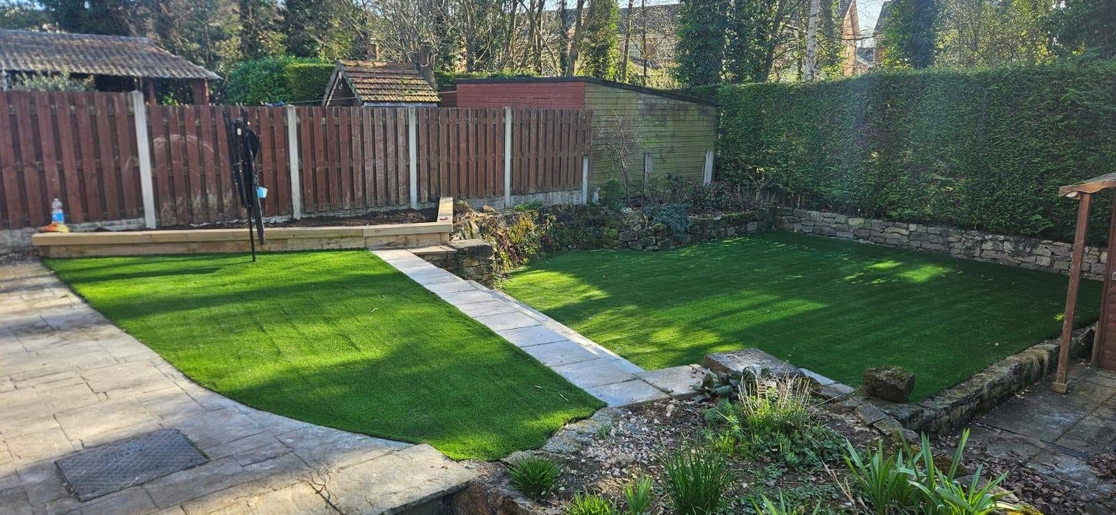 Landscaped garden with artificial grass and a paved path
