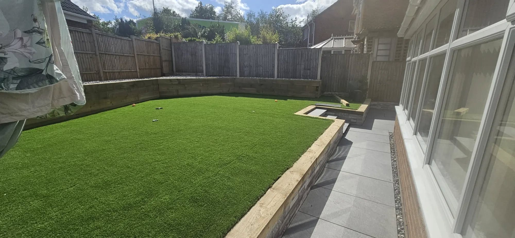 Artificial grass lawn beside a porcelain path