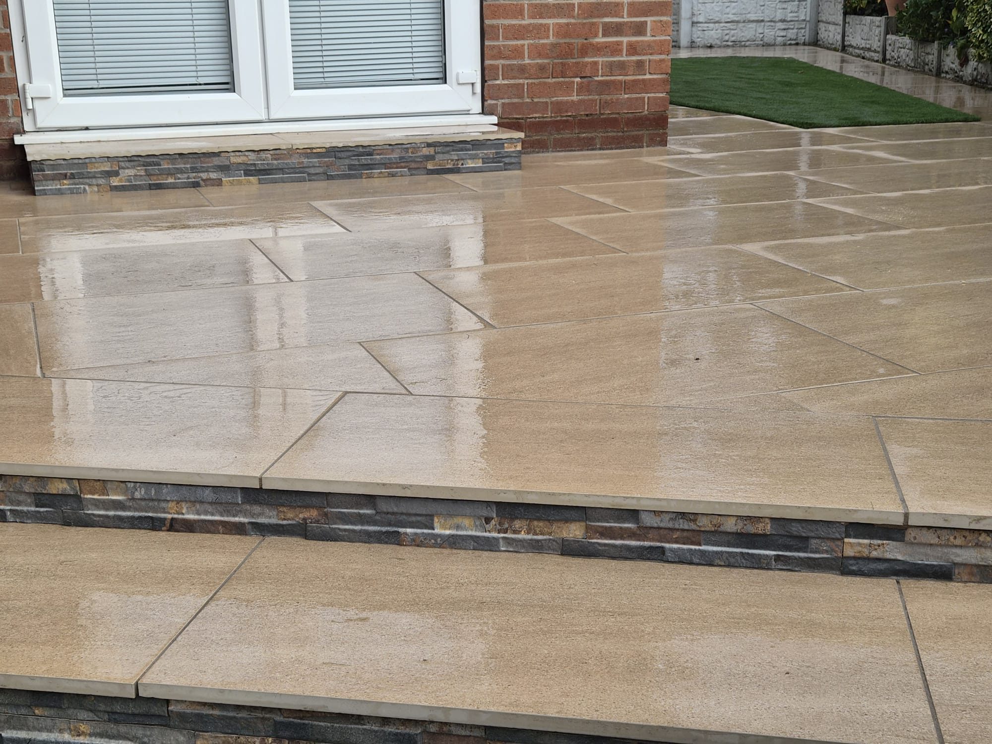 Beige porcelain patio step with a slate-effect riser