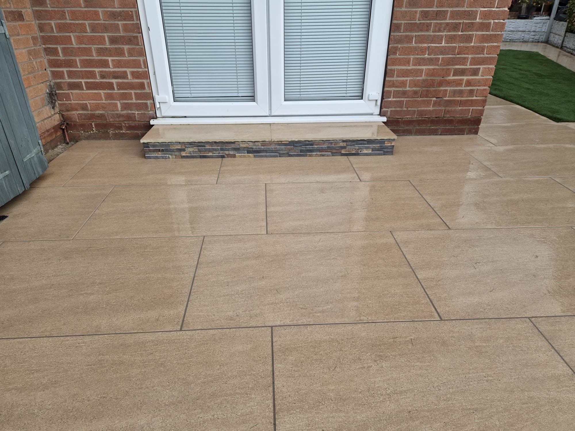 Beige porcelain patio outside French doors