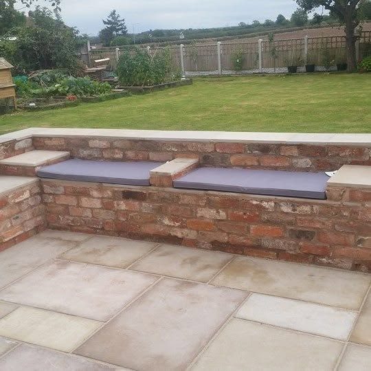 Indian stone patio with a brick seating wall