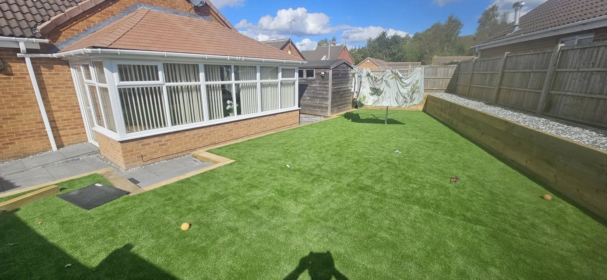 Artificial grass lawn behind a bungalow