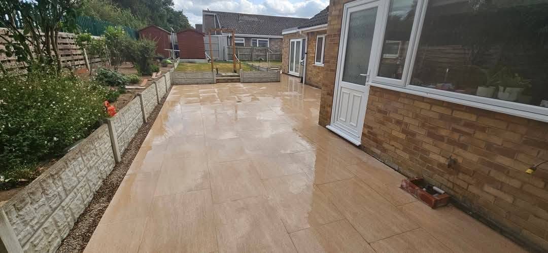 Long beige porcelain patio along the back of a house